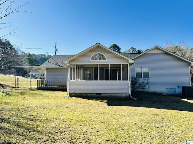 rear view of property with crawl space, central AC, a yard, and a sunroom