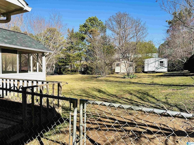 view of yard featuring a sunroom and fence