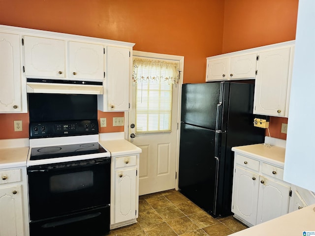 kitchen with electric range, under cabinet range hood, freestanding refrigerator, white cabinets, and light countertops