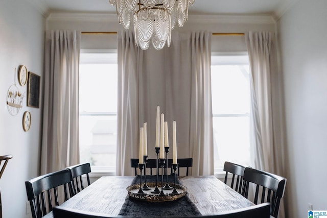 dining area featuring a notable chandelier, plenty of natural light, and ornamental molding