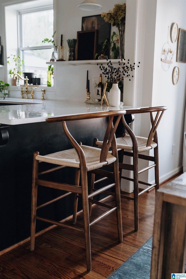 interior space featuring baseboards and wood finished floors