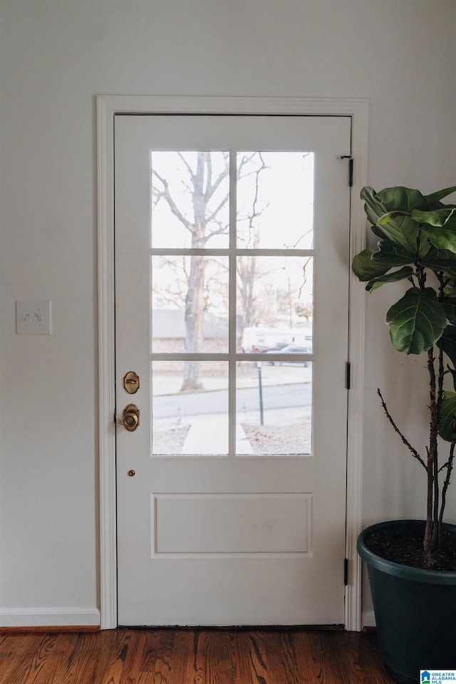 entryway with dark wood-style floors and a healthy amount of sunlight