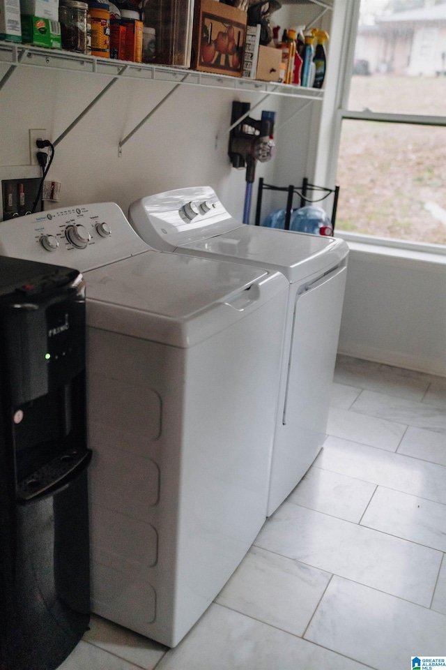 washroom with washing machine and dryer and laundry area