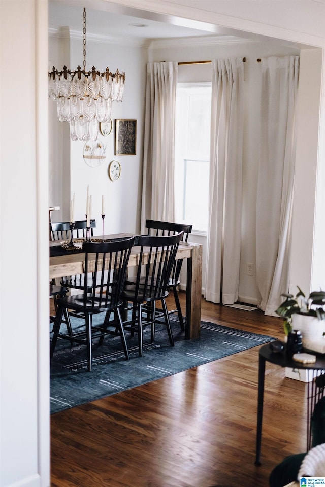 dining space featuring a chandelier and wood finished floors