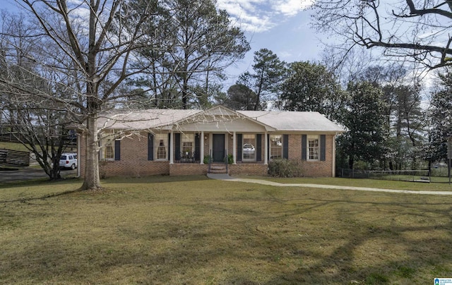 view of front of house with brick siding and a front lawn