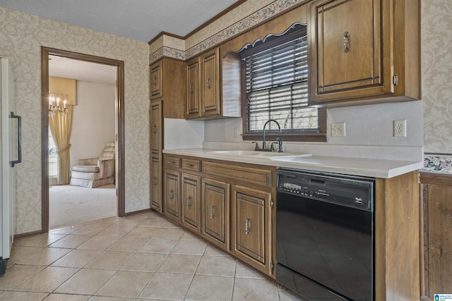 kitchen featuring brown cabinets, wallpapered walls, black dishwasher, and a sink