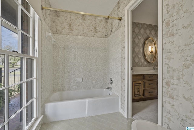 bathroom featuring tile patterned floors, bathing tub / shower combination, vanity, and wallpapered walls