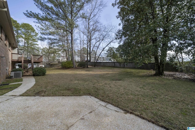 view of yard featuring a patio area, stairs, and a fenced backyard