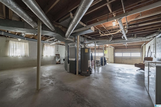 basement with water heater, heating unit, and concrete block wall