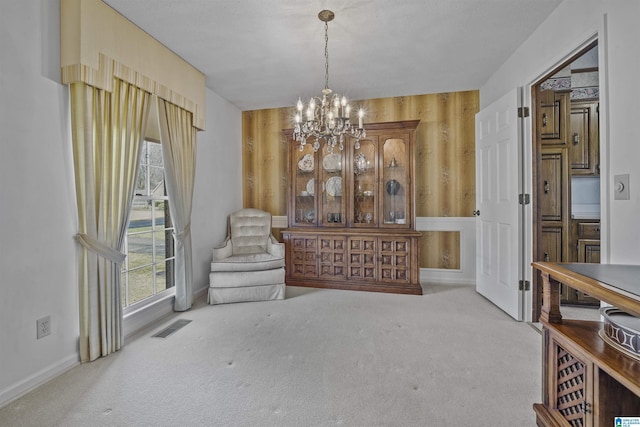 living area with a notable chandelier, carpet, and visible vents