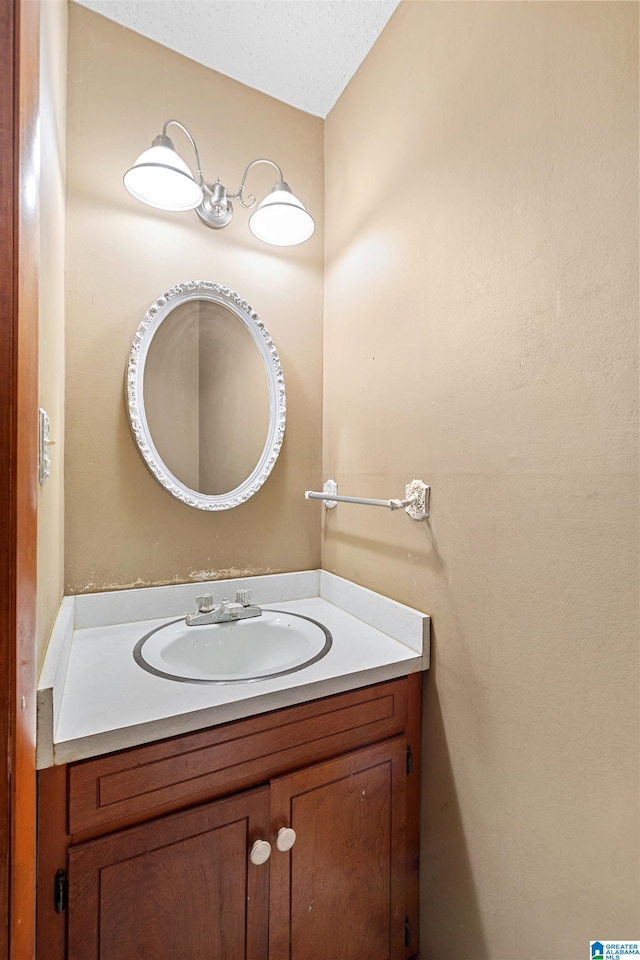 bathroom with a textured ceiling and vanity