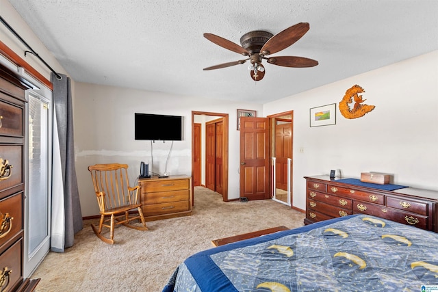 carpeted bedroom with a ceiling fan, baseboards, and a textured ceiling