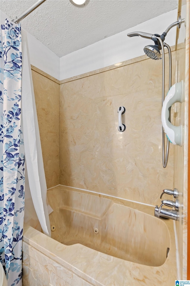 bathroom with shower / bathtub combination with curtain and a textured ceiling