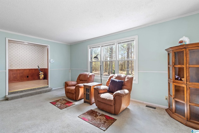 living area with visible vents, a textured ceiling, carpet flooring, and crown molding