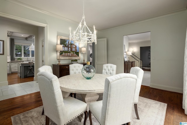 dining room with stairs, wood finished floors, baseboards, and a chandelier