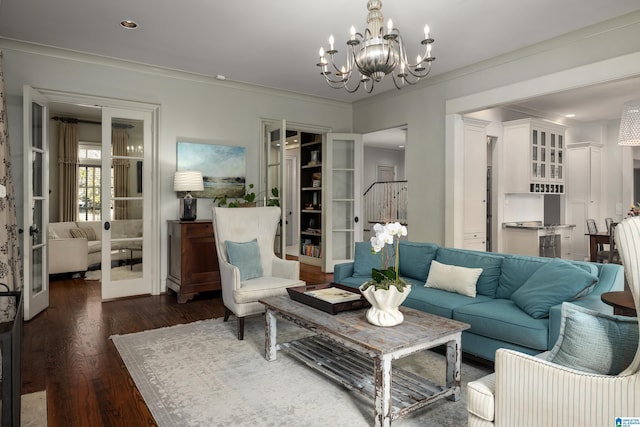 living room featuring a chandelier, dark wood-style floors, and crown molding