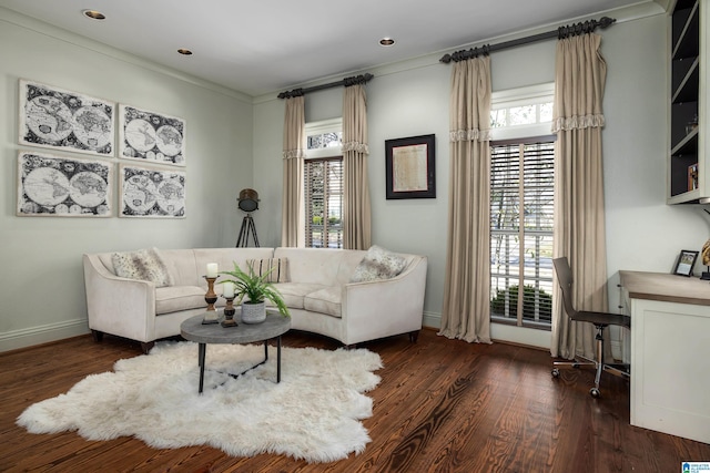 living room with wood finished floors, baseboards, and a wealth of natural light