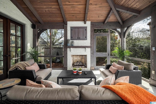 sunroom featuring beam ceiling and wood ceiling