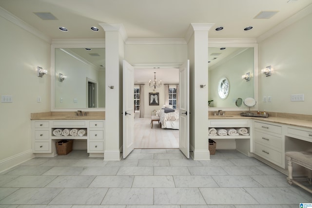 ensuite bathroom with baseboards, ornamental molding, ensuite bathroom, a notable chandelier, and vanity