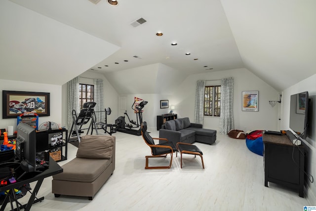 interior space with visible vents, lofted ceiling, and wood finished floors