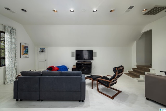 living room featuring visible vents and vaulted ceiling