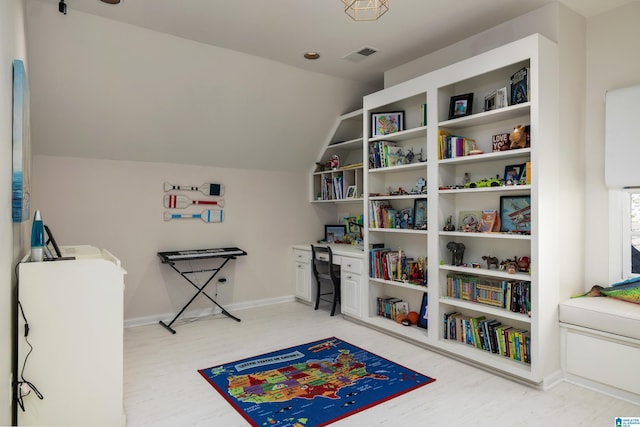 recreation room featuring visible vents, baseboards, light wood-style floors, and lofted ceiling