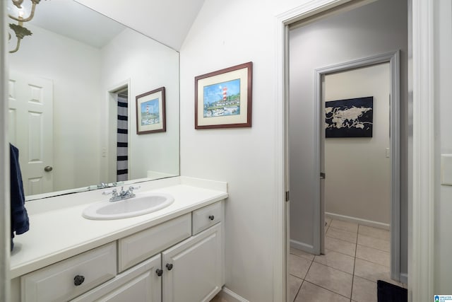 bathroom with tile patterned flooring, vanity, and baseboards