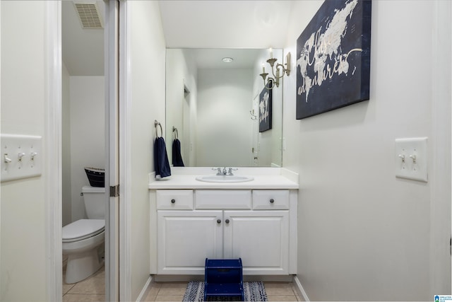 bathroom with tile patterned floors, visible vents, toilet, baseboards, and vanity