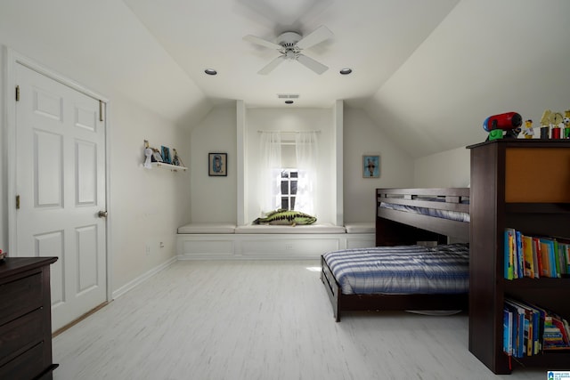 bedroom featuring visible vents, baseboards, lofted ceiling, and wood finished floors