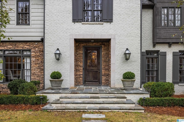 entrance to property featuring stone siding