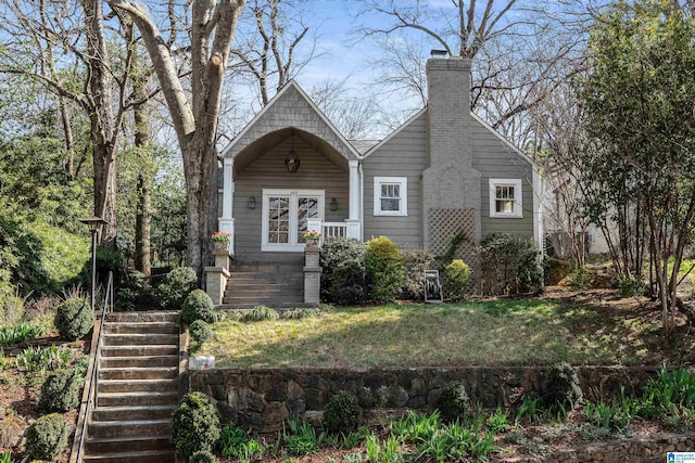 view of front of home with stairway and a chimney