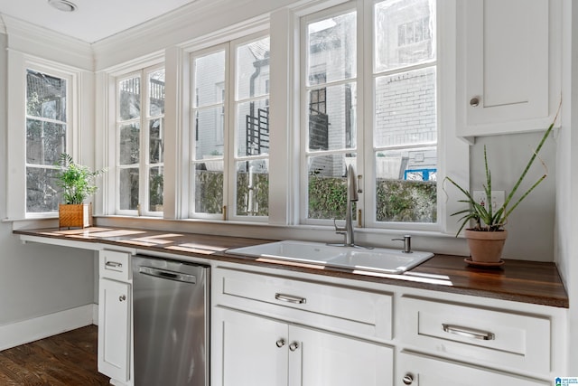 kitchen featuring a sink, stainless steel dishwasher, dark wood-style floors, and white cabinetry