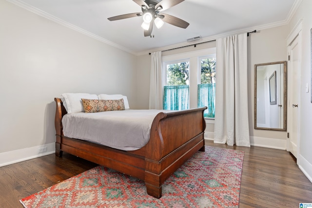 bedroom with visible vents, wood finished floors, baseboards, and ornamental molding