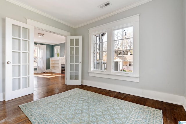 interior space featuring french doors, visible vents, wood finished floors, and crown molding