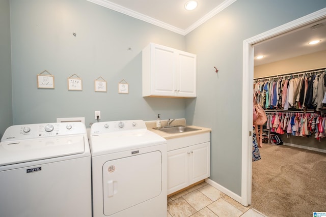 washroom featuring cabinet space, ornamental molding, a sink, light carpet, and washing machine and dryer