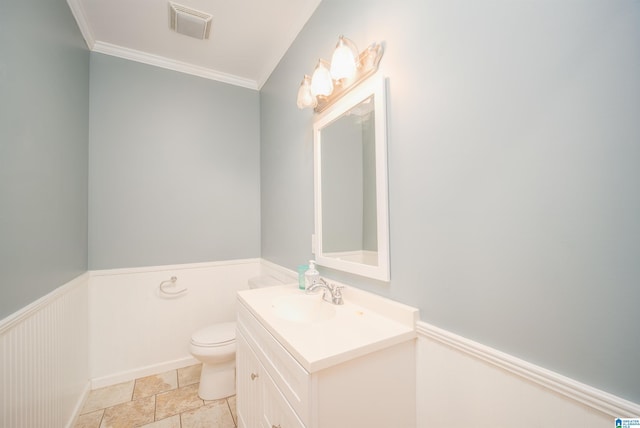 half bath with visible vents, crown molding, a wainscoted wall, toilet, and vanity