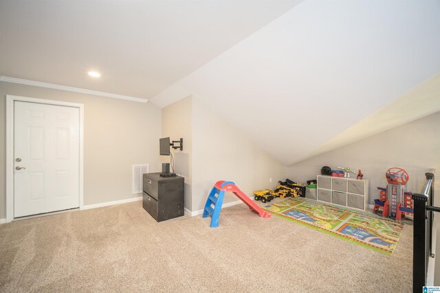 recreation room with visible vents, carpet floors, baseboards, vaulted ceiling, and crown molding