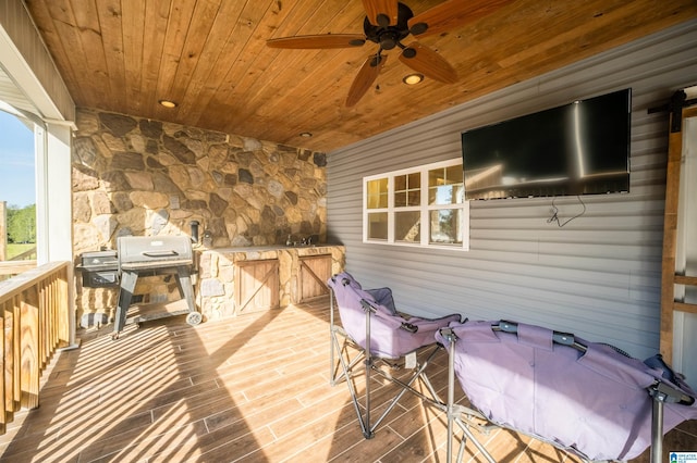 wooden terrace with a ceiling fan and grilling area