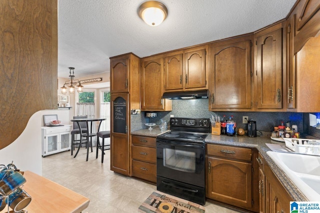 kitchen featuring a sink, under cabinet range hood, black electric range oven, brown cabinets, and backsplash