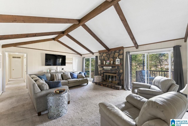 carpeted living room featuring a stone fireplace and lofted ceiling with beams