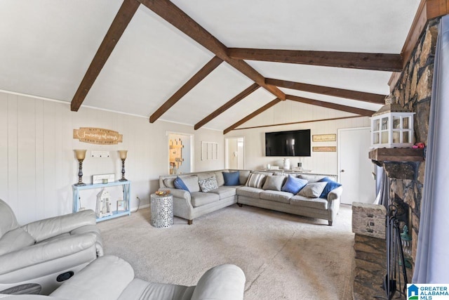 carpeted living room featuring a brick fireplace and vaulted ceiling with beams