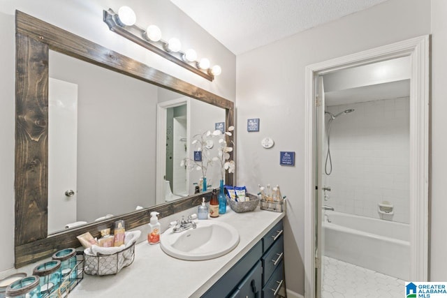 full bath with vanity, bathtub / shower combination, tile patterned flooring, and a textured ceiling