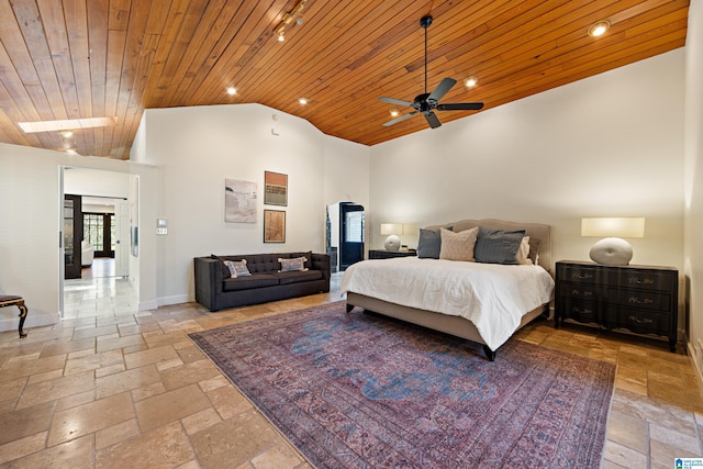 bedroom featuring lofted ceiling, wood ceiling, baseboards, and stone tile flooring