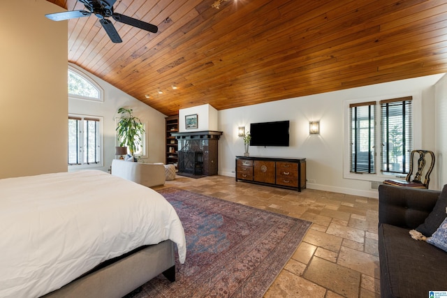 bedroom featuring baseboards, a tiled fireplace, stone tile floors, wooden ceiling, and high vaulted ceiling