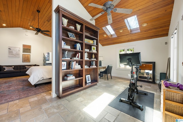 exercise room with stone tile floors and wood ceiling