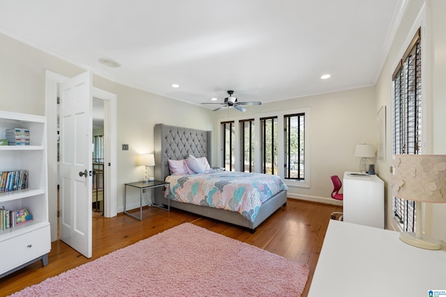 bedroom featuring baseboards, ornamental molding, hardwood / wood-style floors, recessed lighting, and a ceiling fan