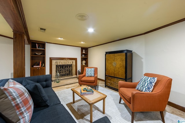 living area featuring visible vents, baseboards, a fireplace with raised hearth, and ornamental molding