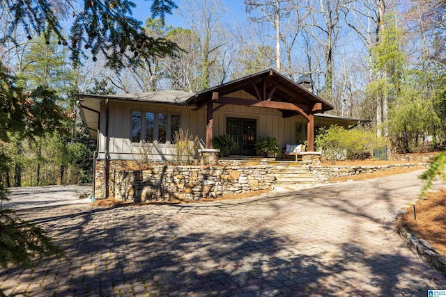 view of front facade featuring board and batten siding and a chimney