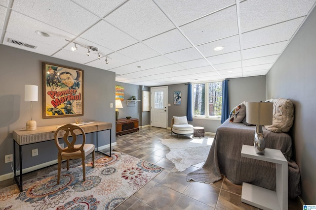 tiled living room with visible vents, rail lighting, a paneled ceiling, and baseboards