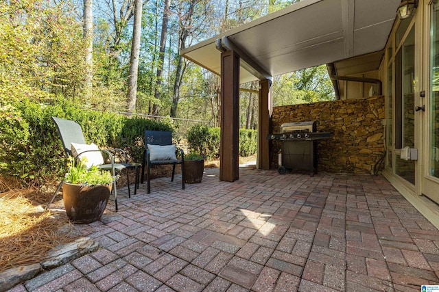 view of patio / terrace with area for grilling and fence